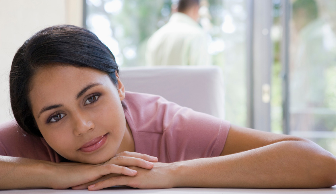 Image of a woman laying her head on her hands and smiling. Do you struggle with stress and anxiety? Learn how effective anxiety therapy in Denver, CO can help you begin reducing your symptoms.